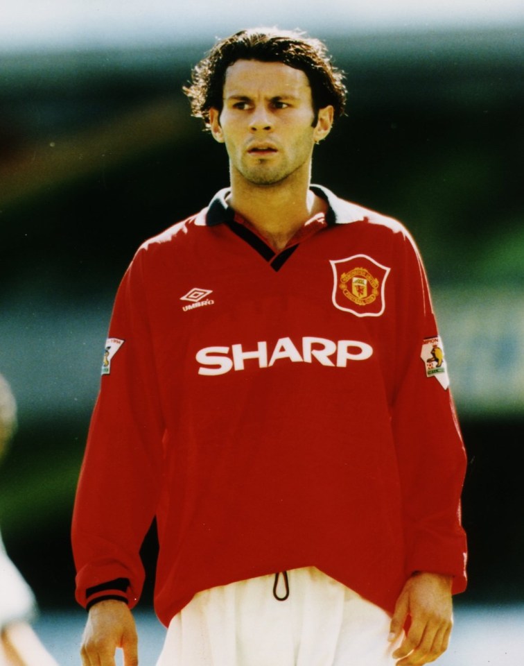 a man in a red sharp jersey stands on a field