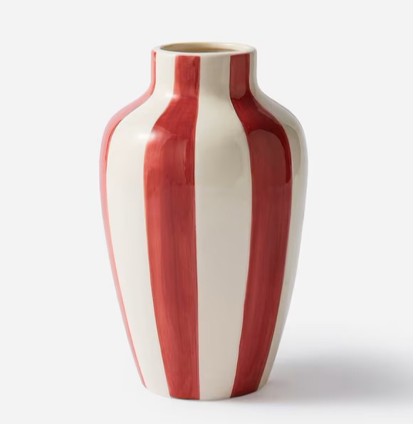 a red and white striped vase on a white background