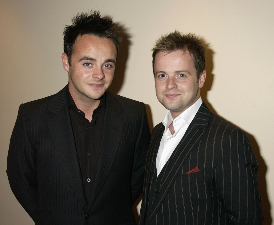 two men in suits are standing next to each other