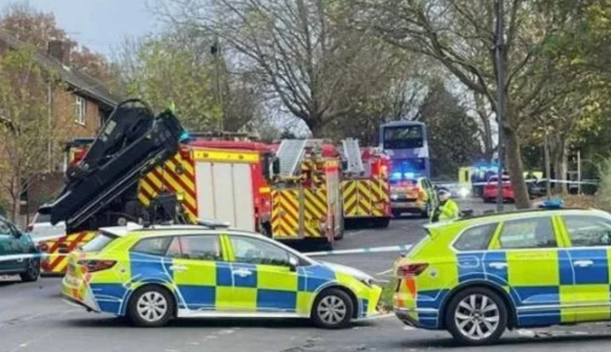 a police car is parked next to a fire truck on the side of the road .