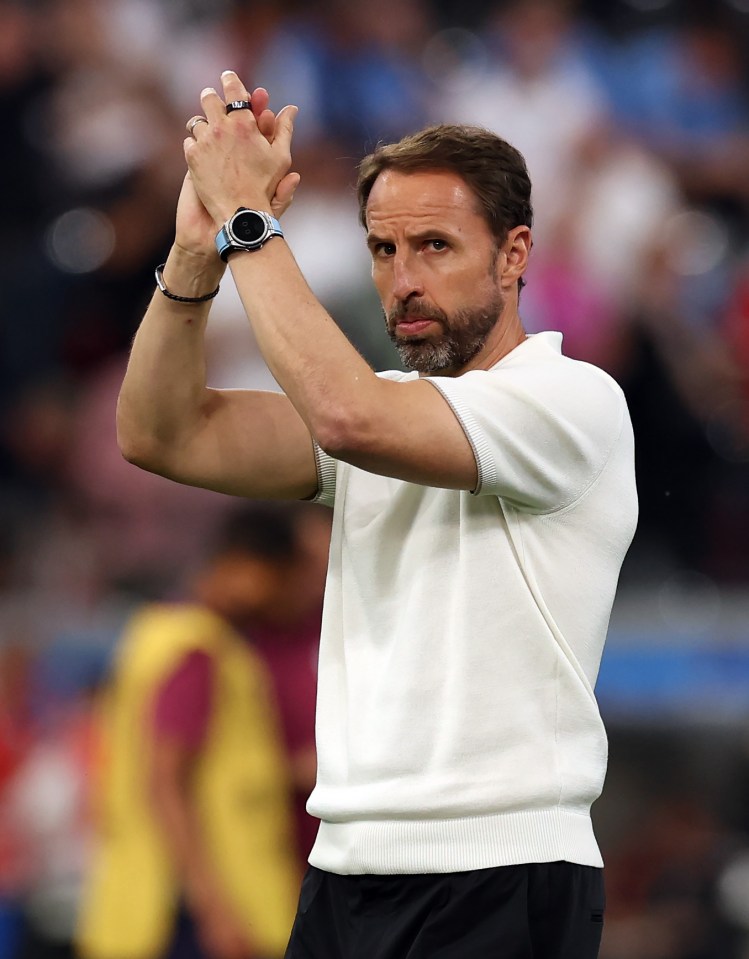 a man wearing a watch on his wrist applauds the crowd