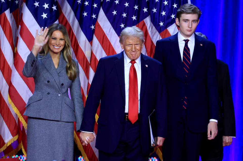 Donald Trump with wife Melania and son Barron, who towers over them both