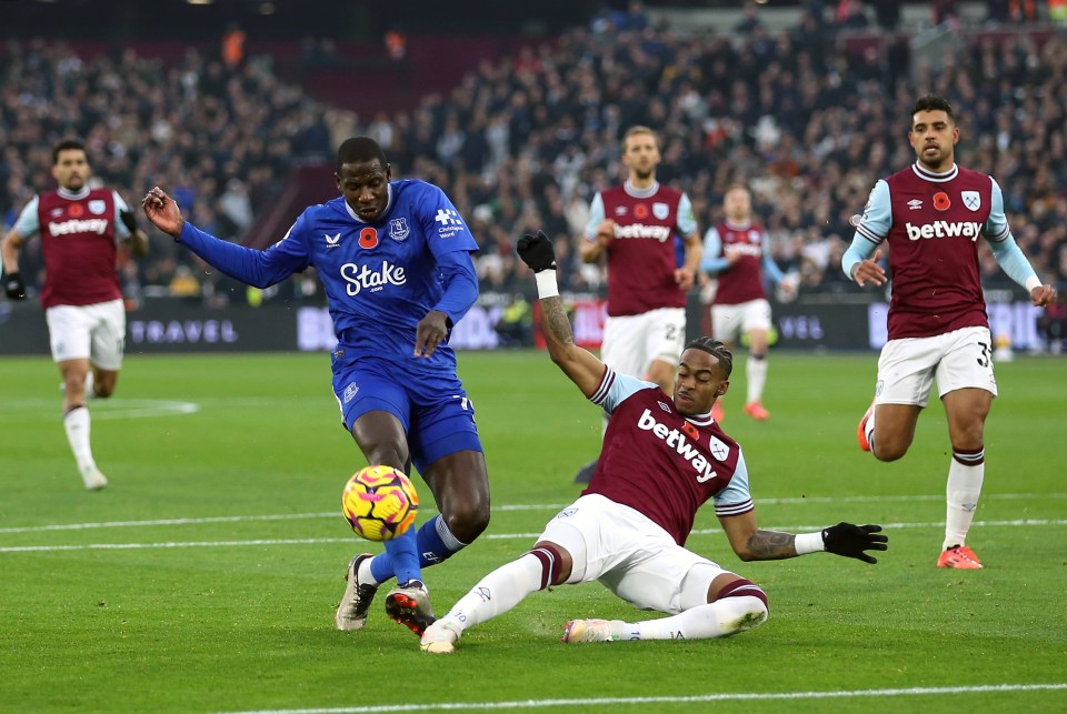 a soccer player in a blue stake jersey kicks the ball