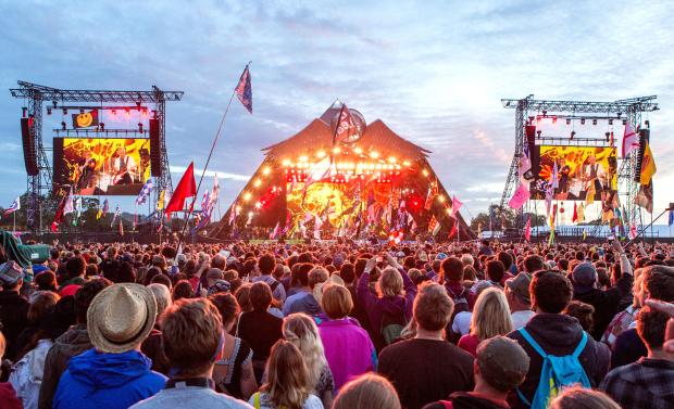 a crowd of people are gathered at a music festival