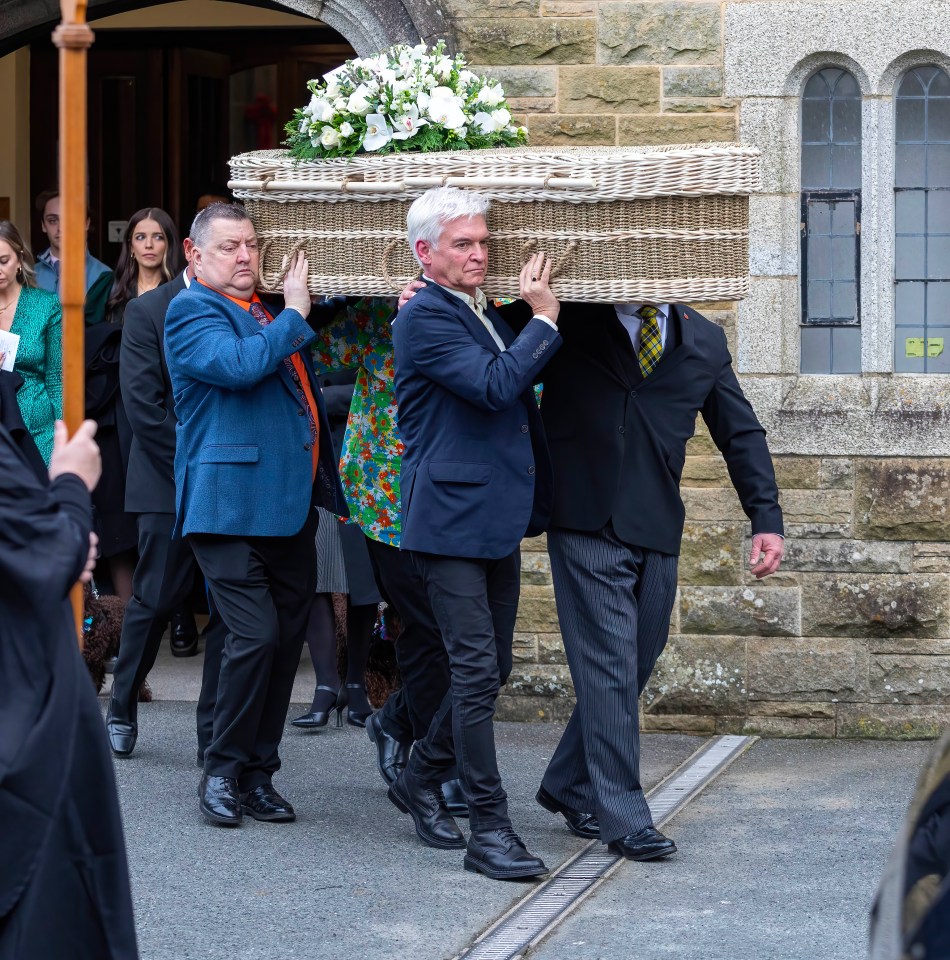 The casket had a beautiful bunch of flowers placed on it