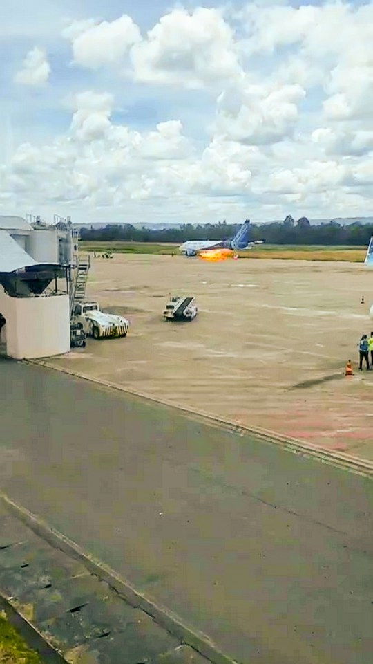 a plane is sitting on the runway with a yellow truck that says ' cargo ' on it