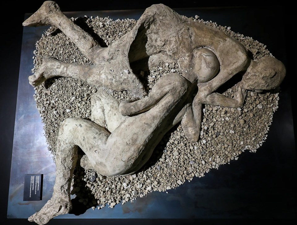 a statue of two people laying on top of each other