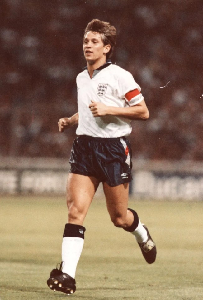 a soccer player wearing a white jersey with the word england on it