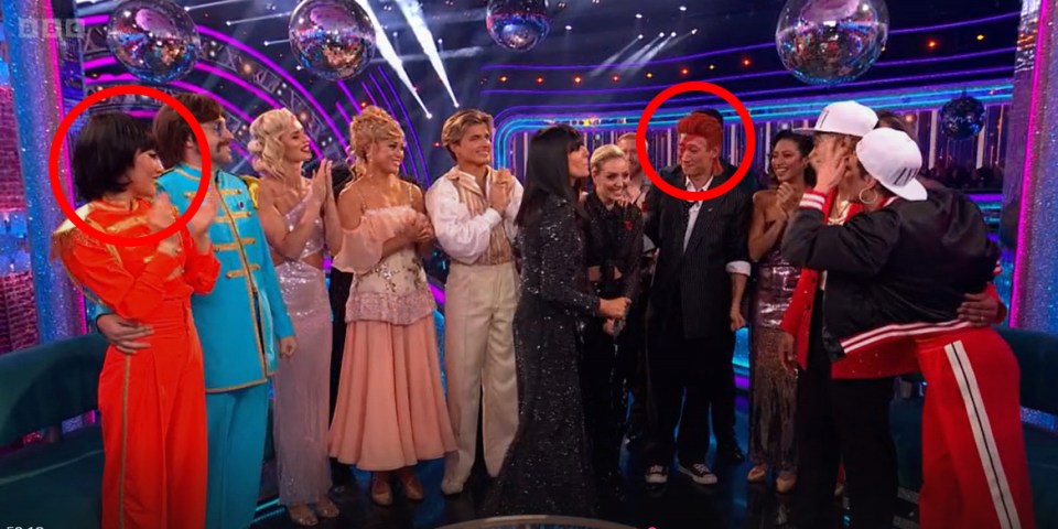 a group of people standing on a stage with bbc written on the bottom