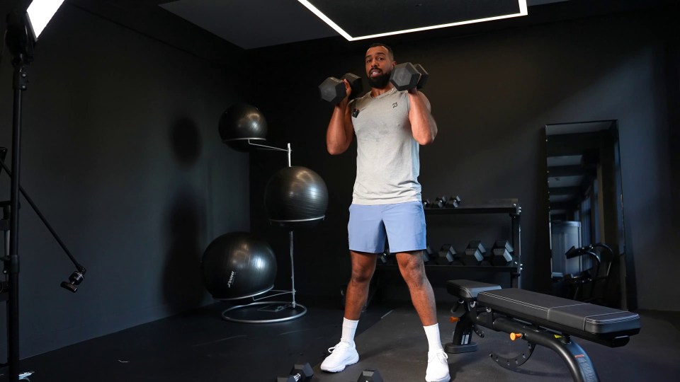 Hold one dumbbell in each hand at your shoulders and squat down