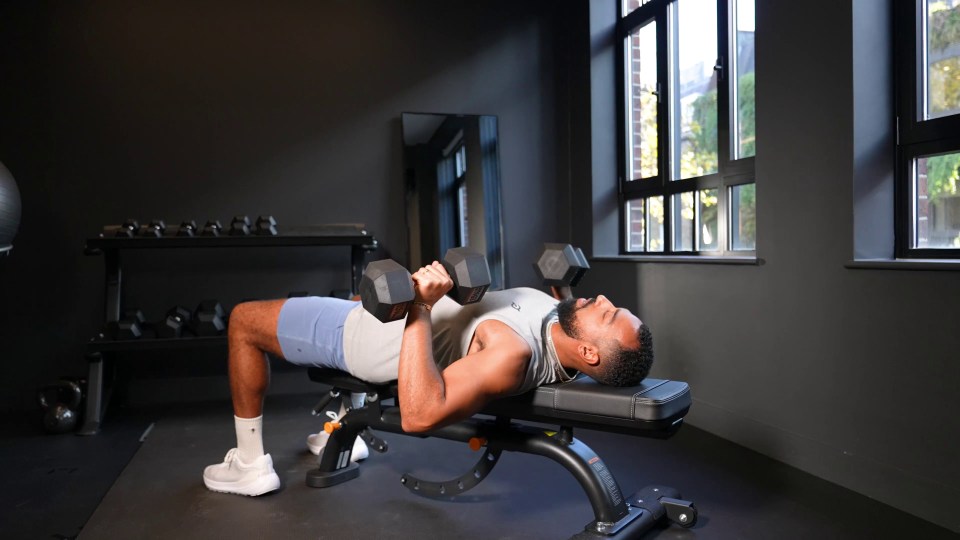 Use a bench and set of dumbbells for a chest press