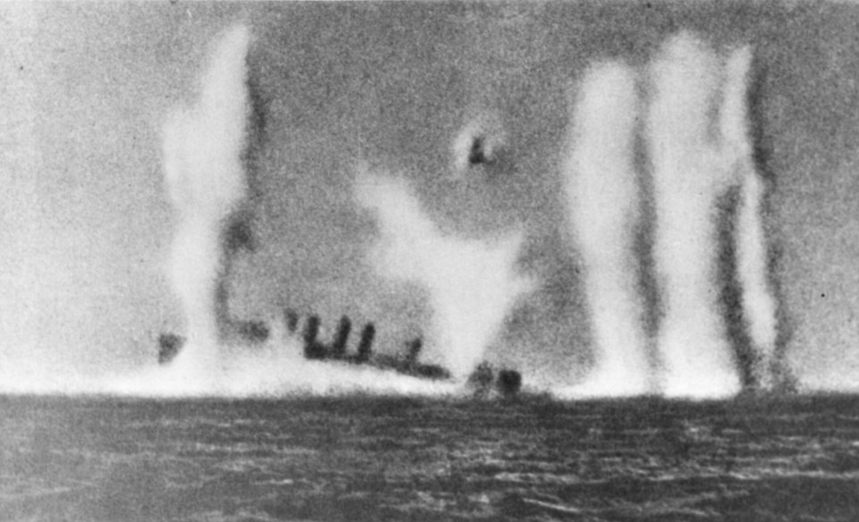 a black and white photo of a ship in the ocean