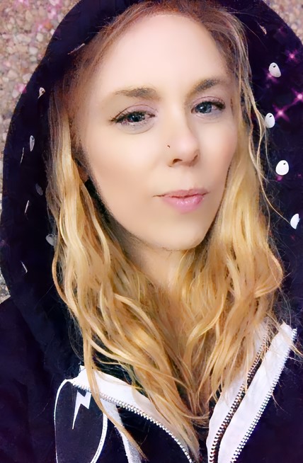 a woman with blonde hair wearing a black hoodie