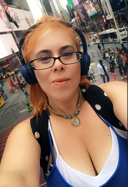 a woman wearing glasses and headphones takes a selfie