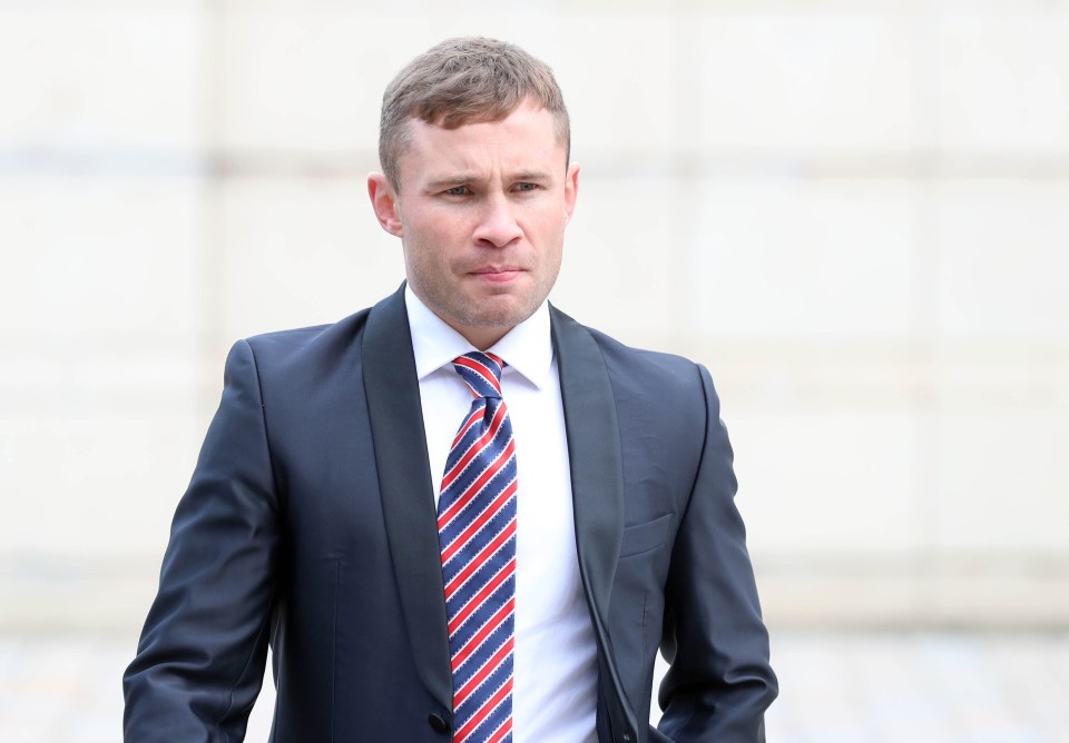 a man in a suit with a red white and blue striped tie