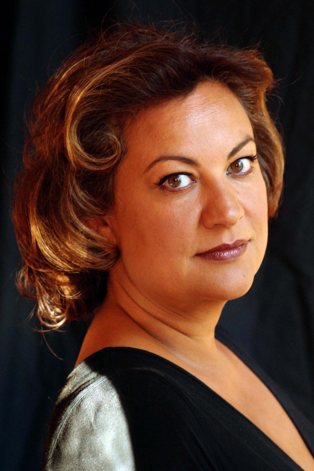 a close up of a woman 's face with a black background