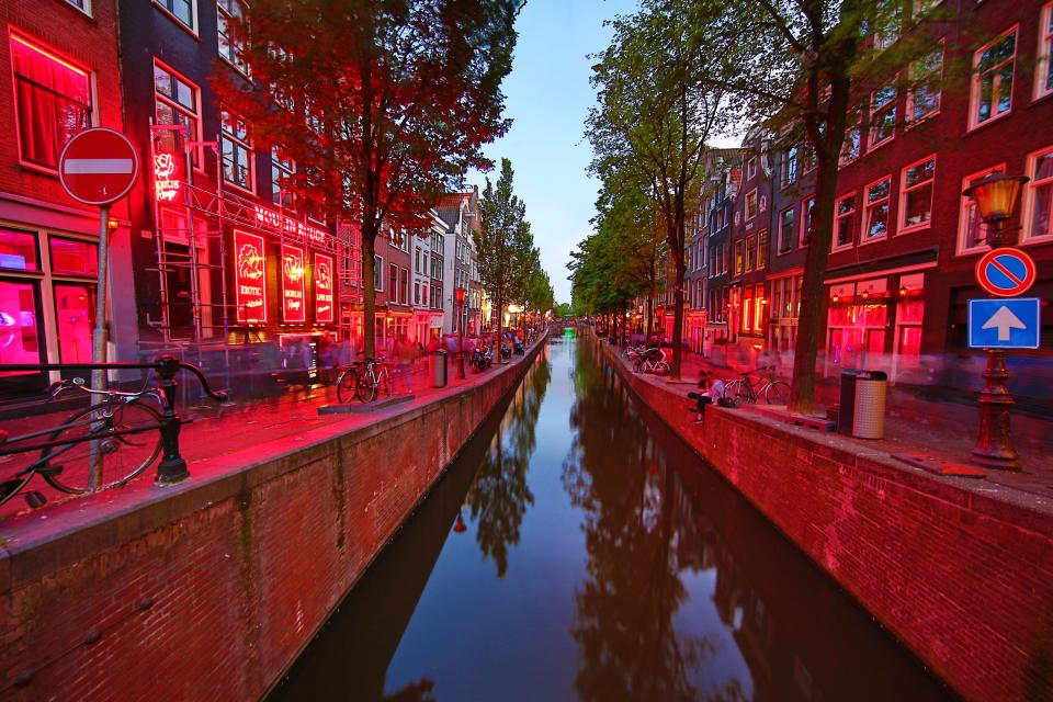 The red light district along the Oudezijds Achterburgwal canal in Amsterdam is the most famous