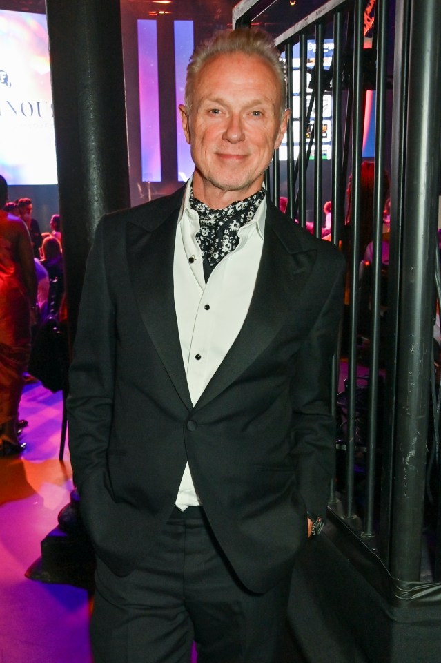 a man in a tuxedo with his hands in his pockets