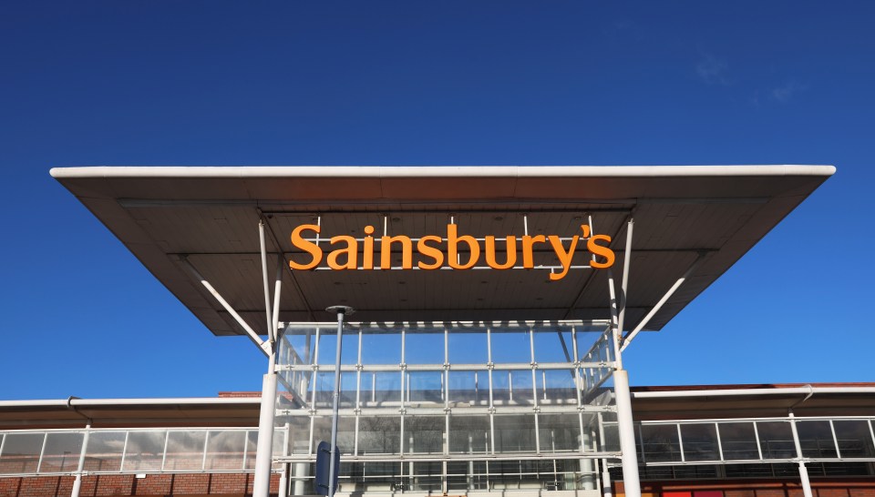 a sainsbury 's store with a blue sky in the background