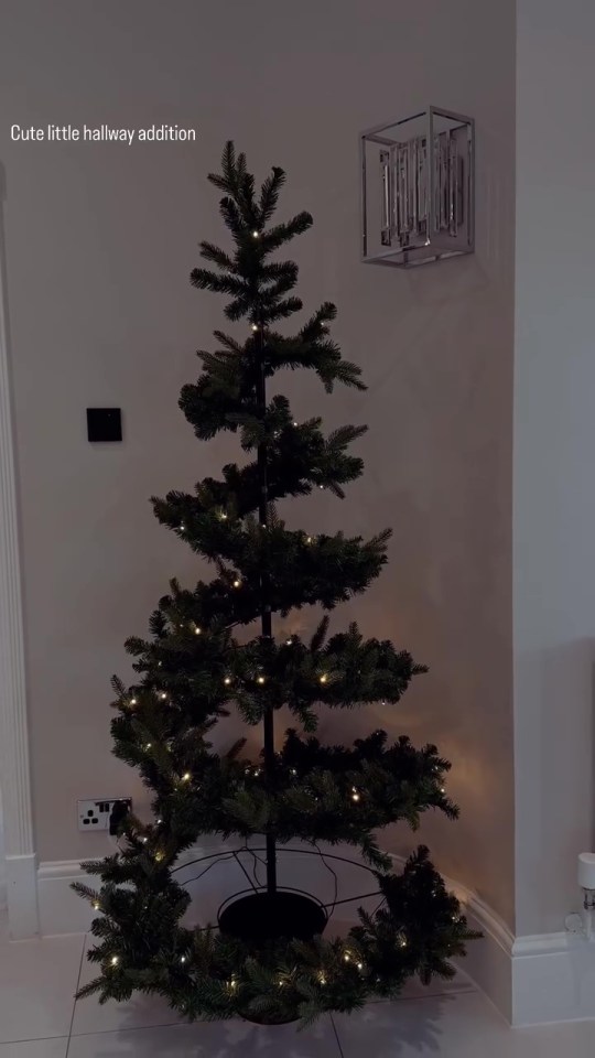 a christmas tree in a hallway with the caption cute little hallway addition