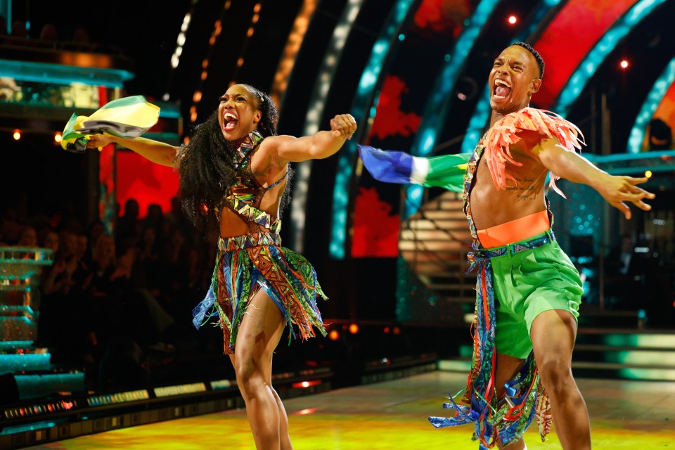 a man and a woman are dancing on a stage