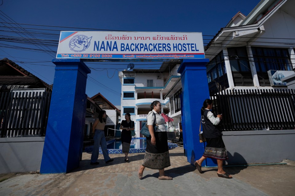 Health officials come out of Nana Backpackers hostel after questioning staff today