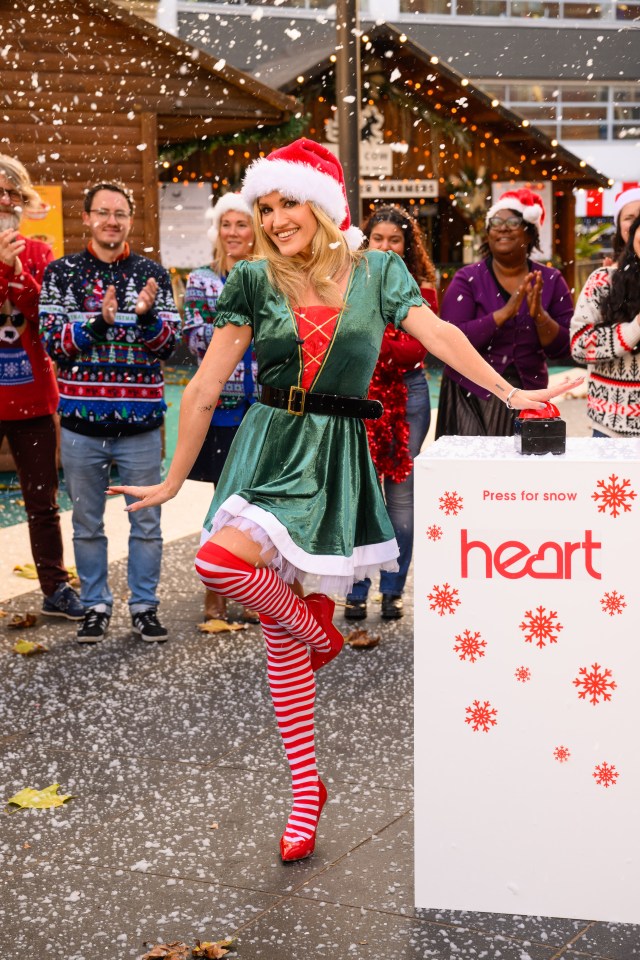 Ashley donned a green dress, Santa hat and heels for the occasion