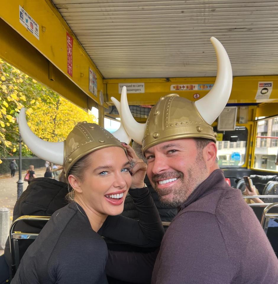 a man and a woman wearing viking hats on a bus