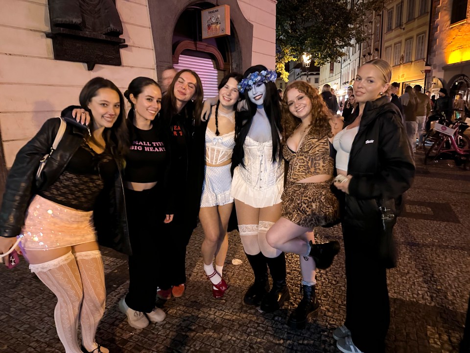 a group of women posing for a picture with one wearing a shirt that says i 'll tell big heart