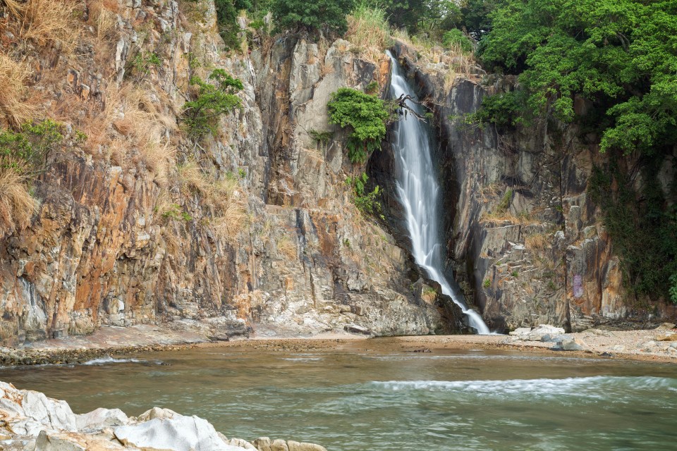 a waterfall in the middle of a rocky area