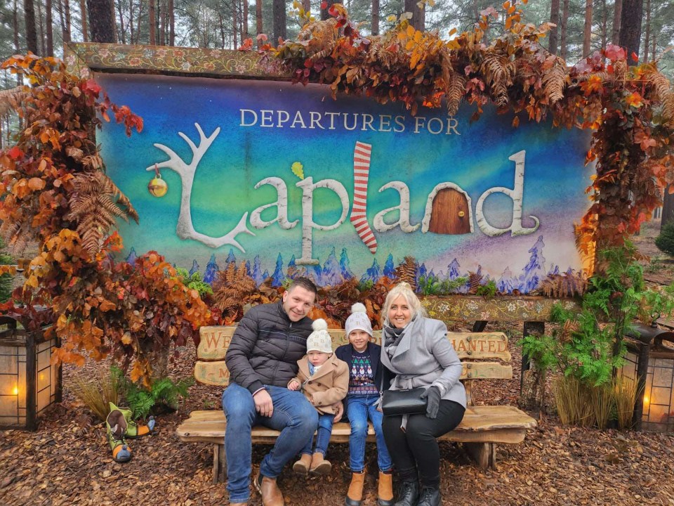 a family posing for a picture with a blue sky in the background