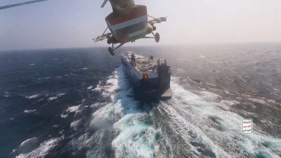 a helicopter is flying over a ship in the ocean