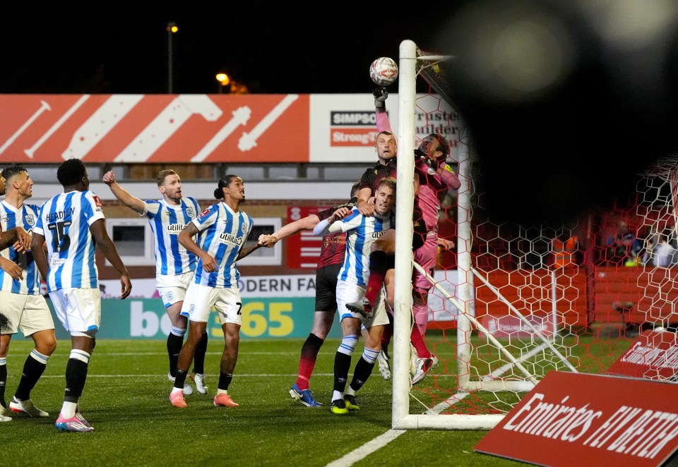 Huddersfield goalkeeper Chris Maxwell could only punch the throw into his own net