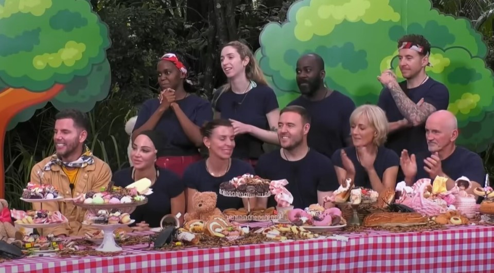 The other campmates look on during the eating challenge