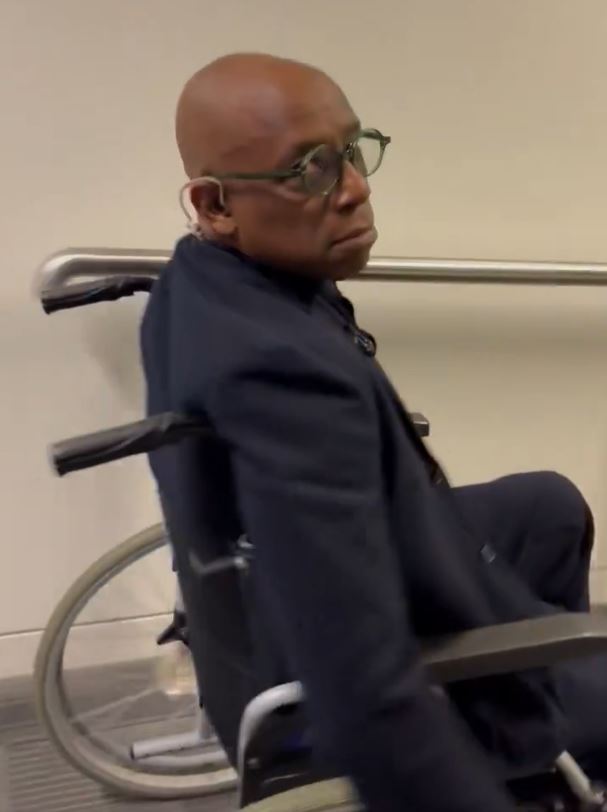 a man in a suit is sitting in a wheelchair