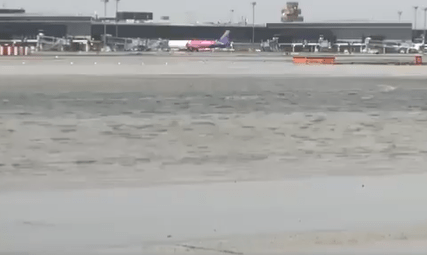 a plane is taking off from an airport runway .