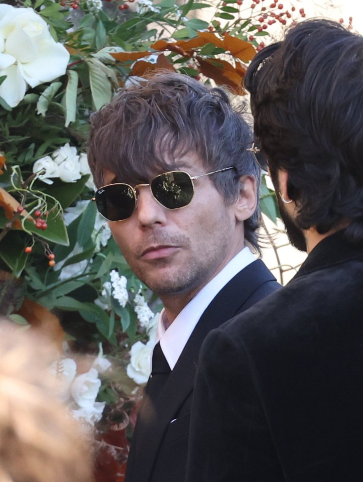 Louis Tomlinson was pictured outside the church wearing black