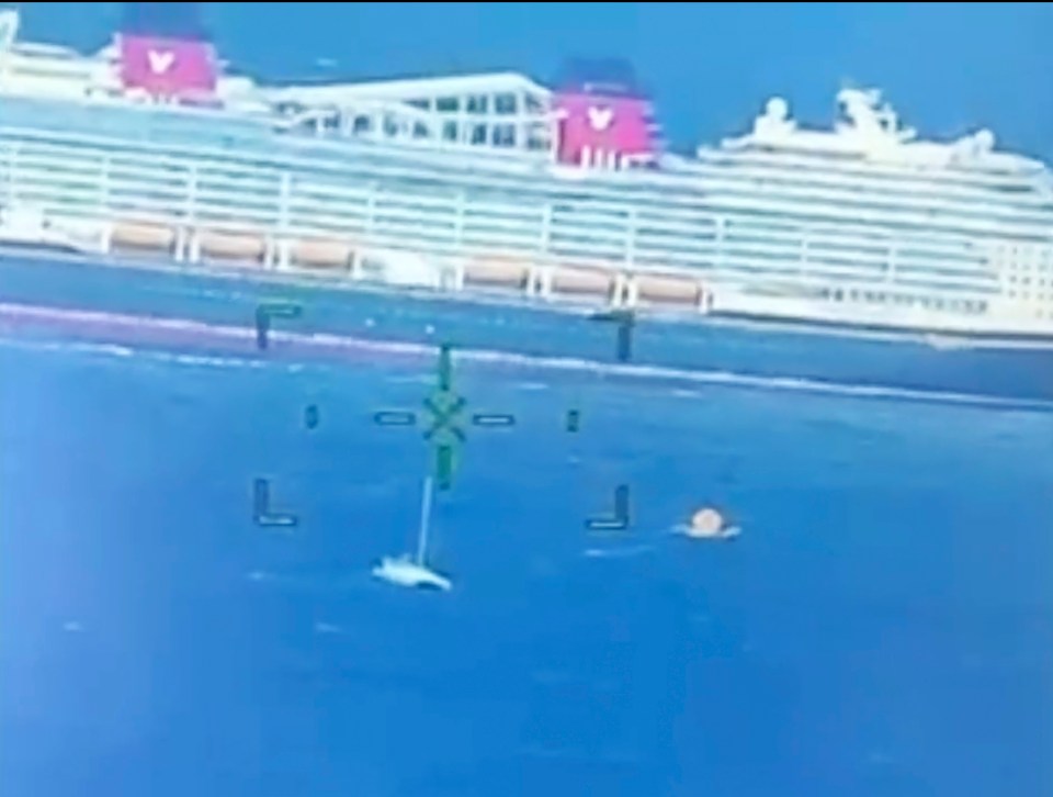 a computer screen shows a large cruise ship in the distance