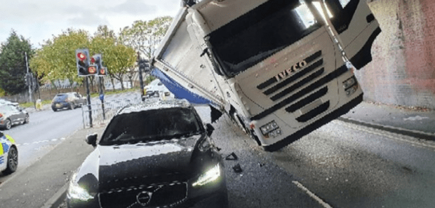 a white iveco truck crashed into a black car