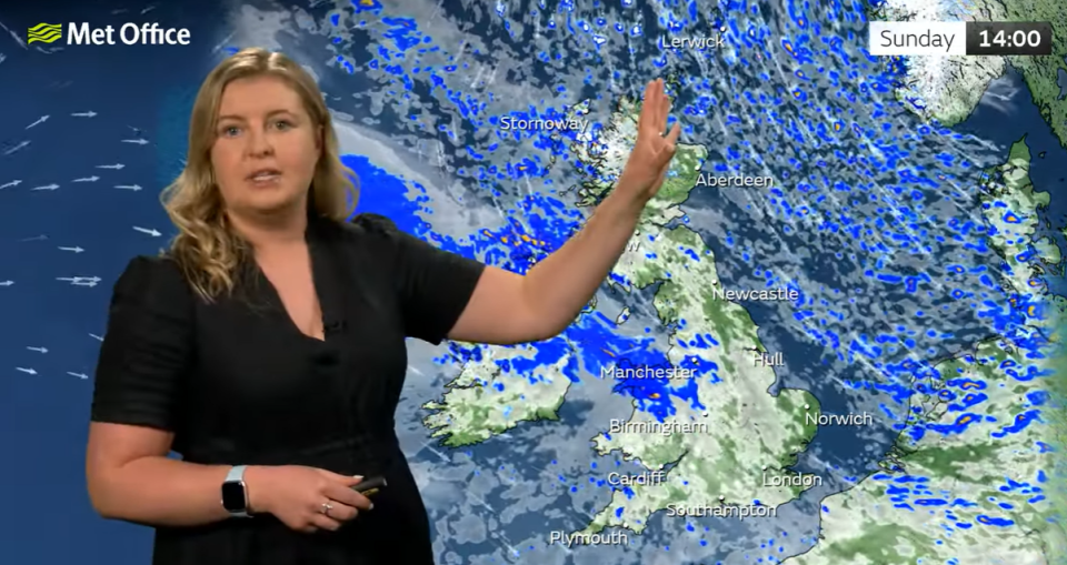 a woman is standing in front of a met office map