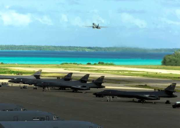 a row of air force planes are parked on a runway