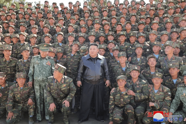 North Korea’s leader Kim Jong Un posing with troops during an inspection at a training base on October