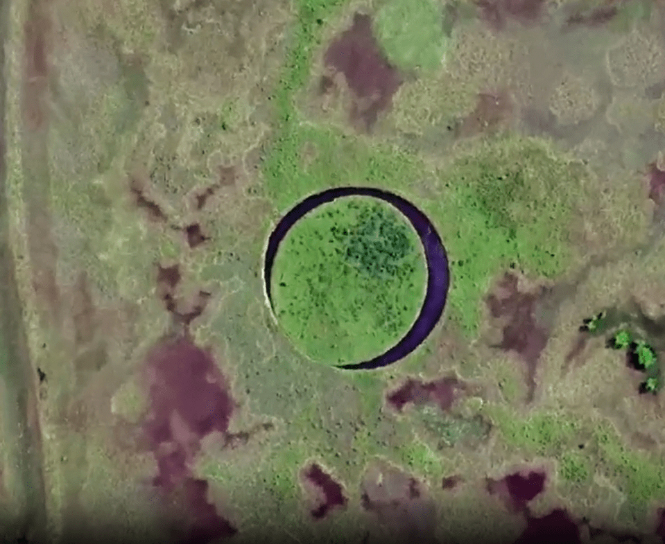 an aerial view of a circle in the middle of a field