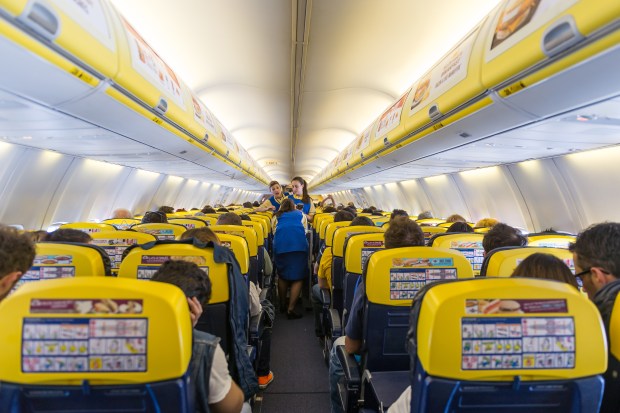 a row of yellow seats on an airplane with the word ryanair on them