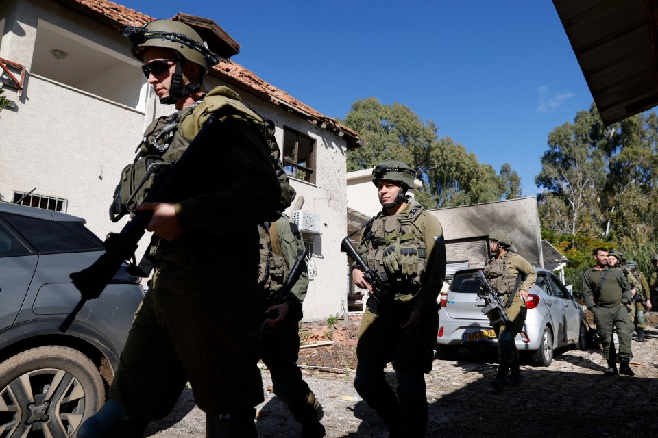 Israeli army forces arrive at the site that received a direct hit by a salvo of rockets fired by Hezbollah from Lebanon in the northern Israeli border town of Kiryat Shmona