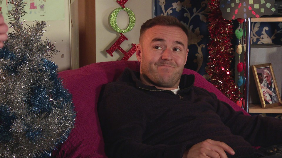 a man sitting in a chair with a christmas tree in the background