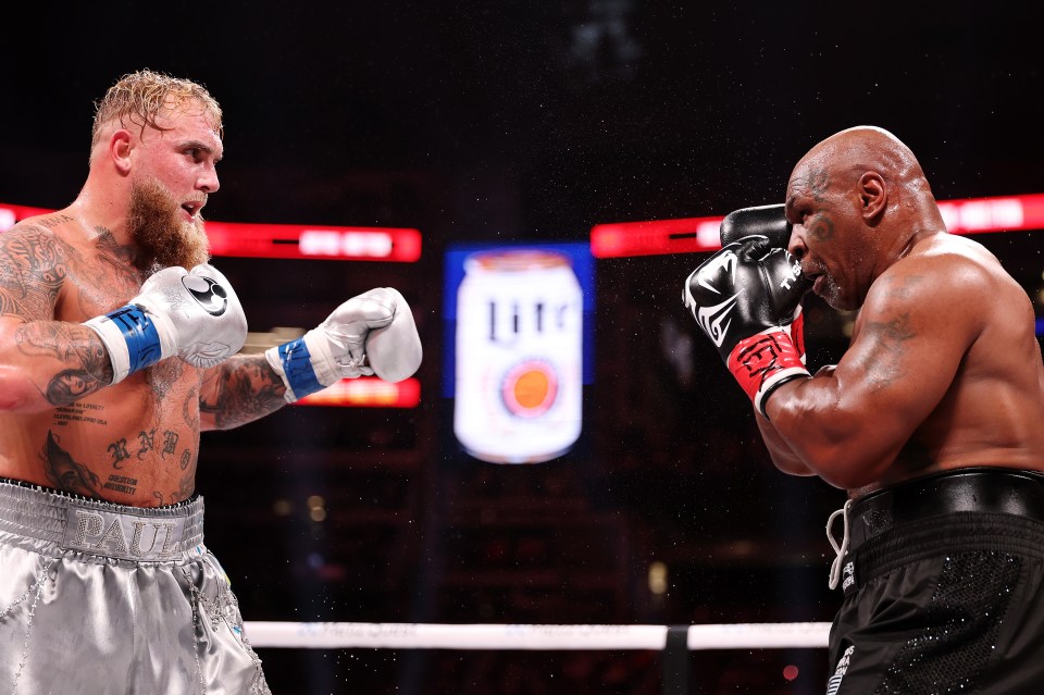 two boxers in a ring with a miller lite can in the background