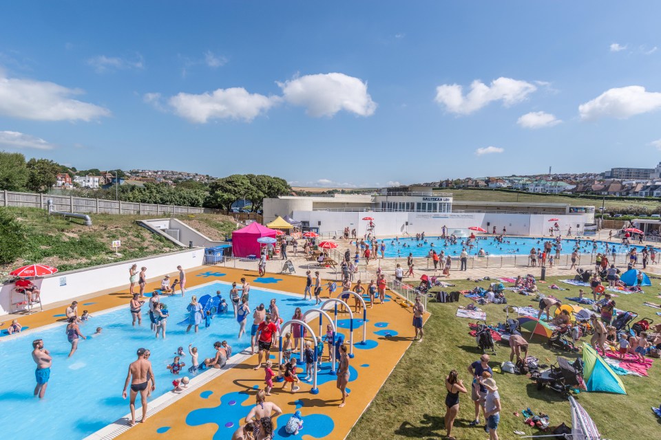 a large group of people are playing in a swimming pool