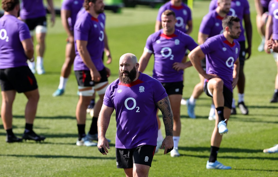 a man with a beard wears a purple o2 shirt