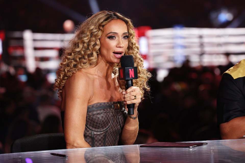 a woman speaking into a microphone with the letter n on it